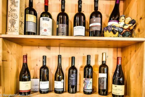 a bunch of bottles of wine on shelves at Berghotel zum Zirm in Collalbo