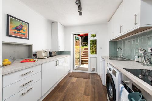 a kitchen with white cabinets and a dishwasher at Private 3Bed-Parking-Sleeps5-By FabAccommodation in Bristol