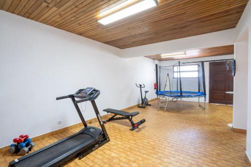 a fitness room with a treadmill and a gym at Villa Ocean Bay Funchal By Empório in Funchal