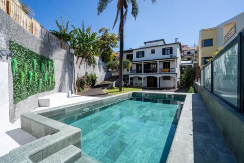 a swimming pool in the backyard of a house at Villa Ocean Bay Funchal By Empório in Funchal