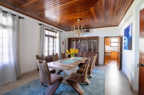 a dining room with a wooden table and chairs at Villa Ocean Bay Funchal By Empório in Funchal