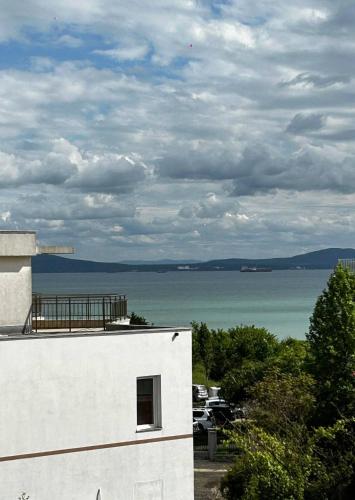 a white building with a view of the water at The better apartment in Burgas City