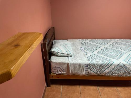 a small bedroom with a bunk bed and a wooden desk at Residencial Don Santiago in Talca