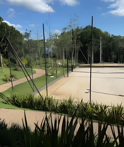 a tennis court with two tennis courts at Acampamento do Bosque in Rodeio