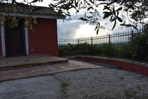 a porch of a house with a fence at Il Casaletto in Palombara Sabina