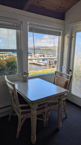 a dining room with a table and two chairs and a window at Tomales Bay Lodge and Marina Inc in Inverness