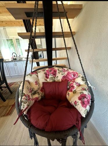 a swing chair with pillows in a living room at Forest Panorama Cabin Brezna in Pluzine