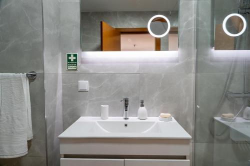 a bathroom with a sink and a mirror at Garajau Sea View in Caniço