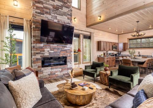 a living room with a couch and a fireplace at Luxury Gatlinburg Cabin, Heated Pool, Theater, Hot Tub in Gatlinburg