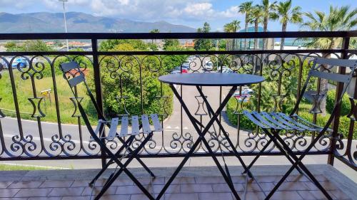a table and two chairs on a balcony with a view at Albenga sweet bilocale nuovissimo in Albenga