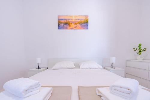 Ένα ή περισσότερα κρεβάτια σε δωμάτιο στο TEMI Apartments
