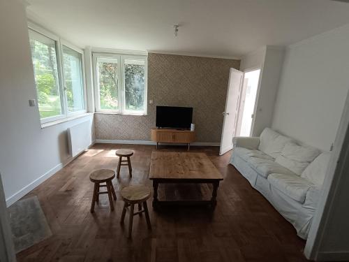 a living room with a couch and a table at Les gîtes du Manoir de Camblain in Camblain-lʼAbbé