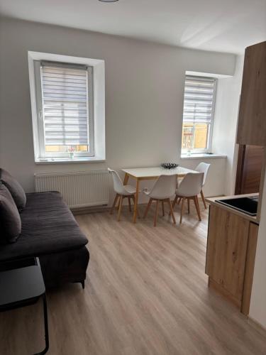 a living room with a table and chairs at Apartman Orlí hnízdo in Liberec