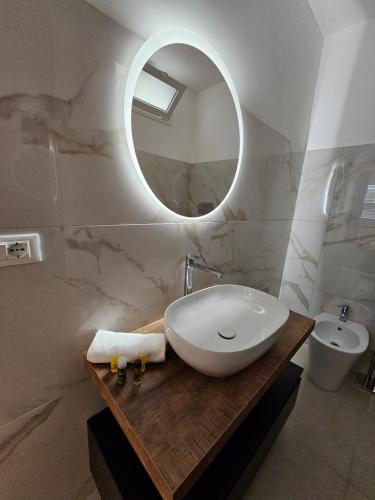 a bathroom with a sink and a mirror at Aura B&B in Pachino