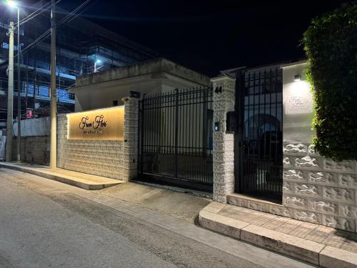 a building with a gate on a street at night at From Flori in Terrasini