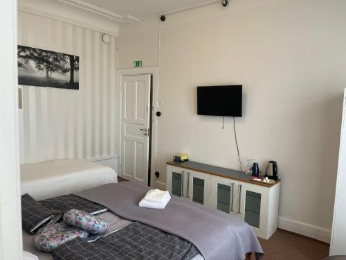 a hotel room with two beds and a flat screen tv at GrandStation Restaurant Room in Oskarshamn