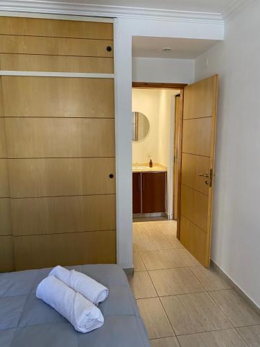 a bedroom with a bed with two towels on it at Complejo Pampa in Santa Rosa