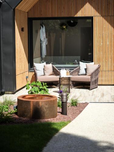 a patio with two chairs and a table at Domaine Le Verbois in Chantilly