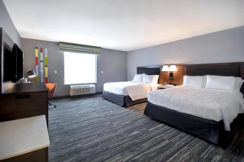 a hotel room with two beds and a flat screen tv at Hampton Inn & Suites Las Vegas Convention Center - No Resort Fee in Las Vegas