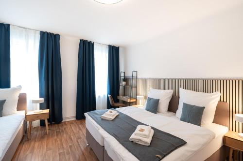 En eller flere senge i et værelse på Benville Freital - 2 Schlafzimmer - Wohnküche - WLAN