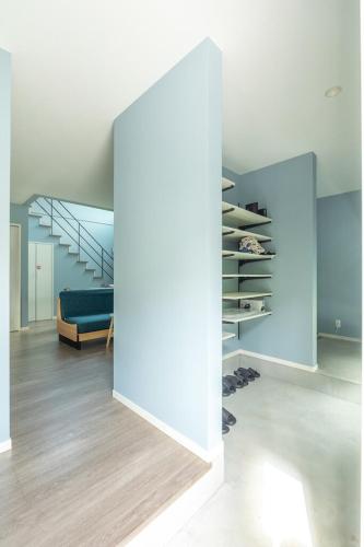 a room with a blue couch and a staircase at RD House in Katsuyama