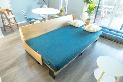 a bed in a living room with a blue mattress at RD House in Katsuyama