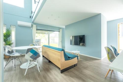 a living room with a couch and a table at RD House in Katsuyama