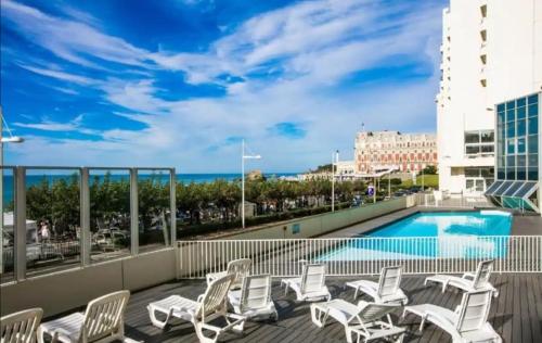 un balcon avec des chaises et une piscine dans l'établissement Studio avec piscine face à la mer, à Biarritz