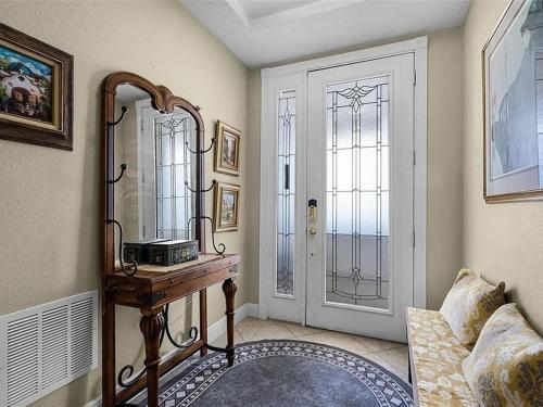 a room with a table and a mirror and a door at Spacious Lakefront Condo in Kissimmee in Kissimmee