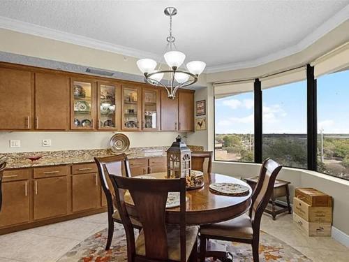 a kitchen with a table and chairs and a dining room at Spacious Lakefront Condo in Kissimmee in Kissimmee