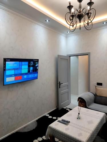 a living room with a tv on a wall at Sumqayıt Abşeron City yaşayış kompleksi in Sumqayyt