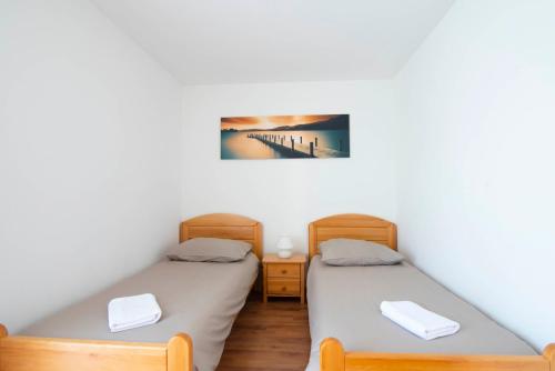 two twin beds in a room with a bridge at Vacation villa Matic with 7 bedrooms in Sinj