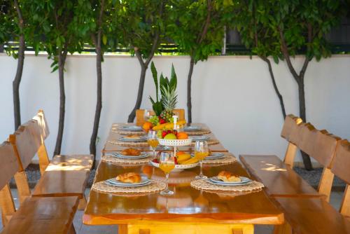 a long wooden table with plates of food on it at Vacation villa Matic with 7 bedrooms in Sinj