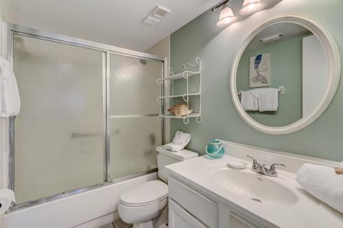 a bathroom with a toilet and a sink and a mirror at 2 Bed/2 Bath Oceanfront condo sleeps 6. Oceanfront deck and pool. in Fernandina Beach