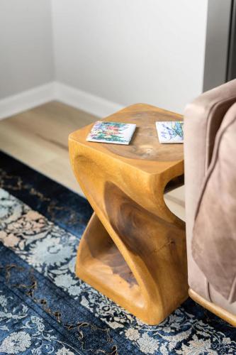 a wooden table with two cards on it next to a chair at Modern Escape w Mountain Views Fire Pit & Swing in Martinsburg