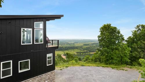 a house on a hill with a view at Modern Escape w Mountain Views Fire Pit & Swing in Martinsburg