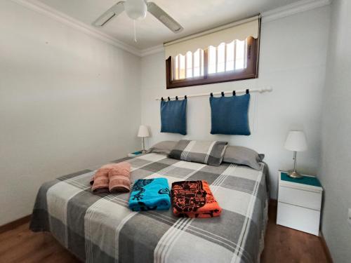 a bedroom with a bed with two bags on it at Los Cristianos Ocean View Suite 2 bedrooms in Los Cristianos