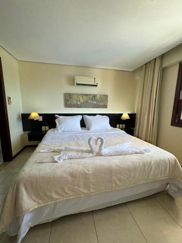 a bedroom with a bed with a heart on it at Kariri Beach Residence in Caucaia