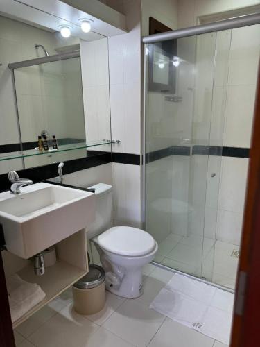 a bathroom with a toilet and a sink and a shower at Kariri Beach Residence in Caucaia