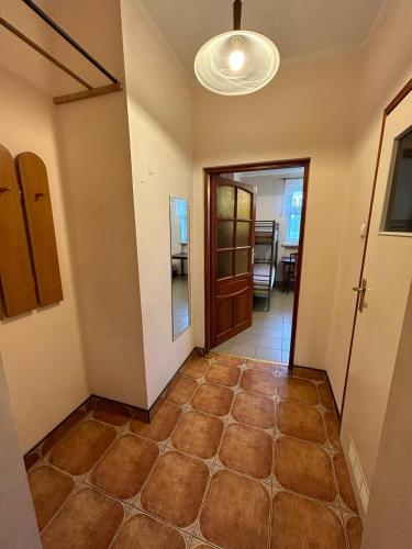 a room with a hallway with a door and a tile floor at Forest Castle in Maurzyze