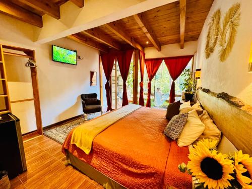 a bedroom with a bed with a sunflower on it at Encino House Hotel Boutique in Valle de Bravo
