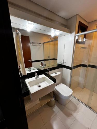a bathroom with a sink and a toilet at Kariri Beach Residence in Caucaia