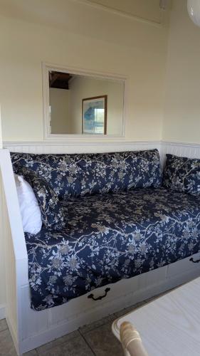 a blue and white couch in a room with a mirror at Tomales Bay Lodge and Marina Inc in Inverness