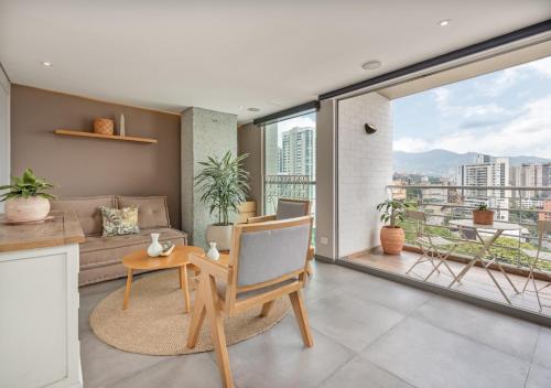 a living room with a couch and a table at Affinity ApartaHotel - Extended Stay in Medellín