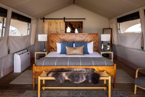 a bedroom with a large bed with a wooden frame at Collective Retreats Governors Island in New York