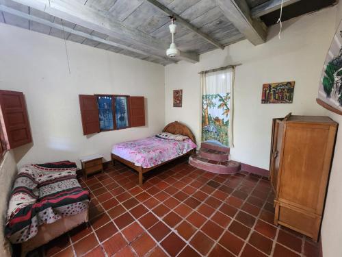 a room with a bed and a table in it at Le bon coin "El Buen Rincon" in Taganga