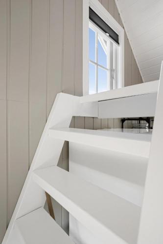 a room with white shelves and a window at Fjordlykke in Porsgrunn