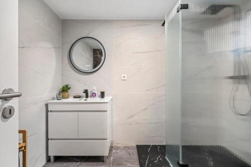 a white bathroom with a sink and a mirror at Villa Pomar, By OP in Senhora do Rosário