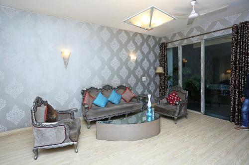 a living room with two couches and a table at Hotel O Gem 92 in New Delhi