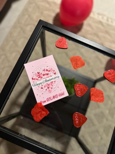 a glass display case with hearts on it at Goland Hotel in Mas'ade